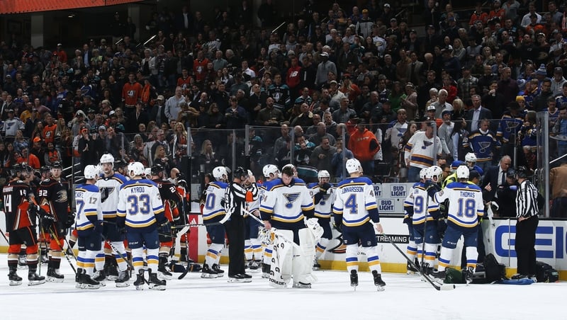 The St Louis Blues and the Anaheim Ducks watch as the paramedics tend to Jay Bouwmeester