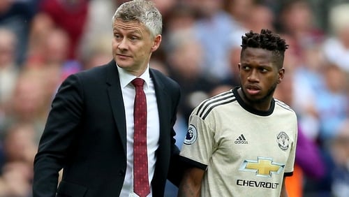 Manchester United manager Ole Gunnar Solskjaer (L) with Fred (right)
