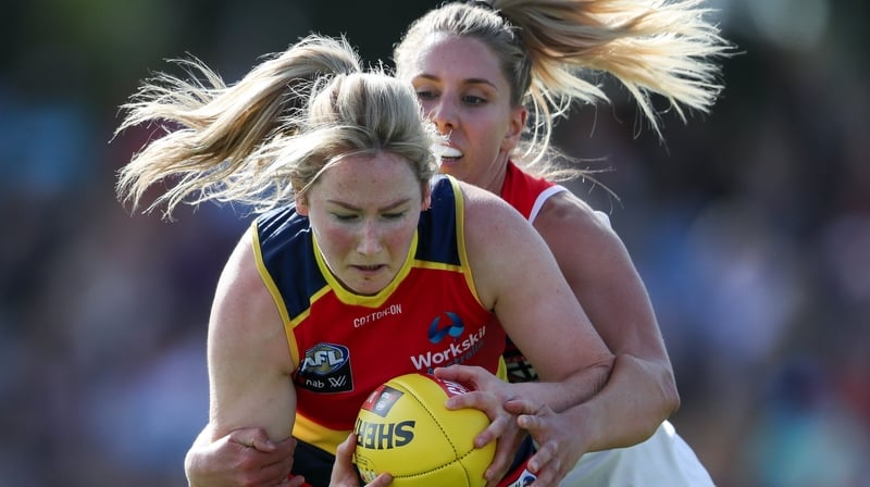 Ailish Considine of the Crows is tackled by St Kilda's Hannah Priest