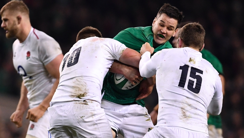 Jonathan Sexton is tackled by Owen Farrell (10) and Elliot Daly (15) of England during the 2019 Six Nations