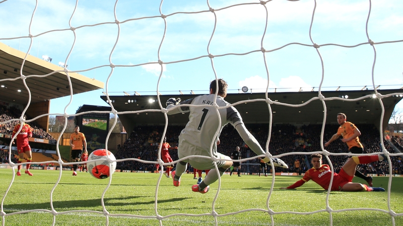 Diogo Jota (R) scores his side's first goal