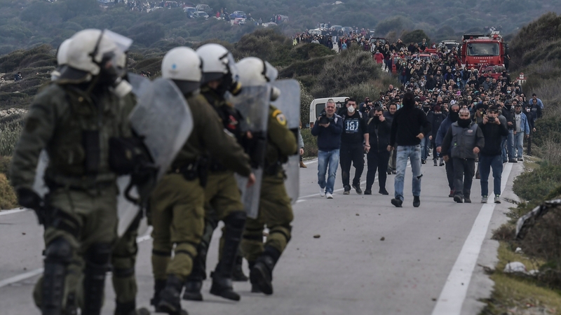 Greek riot police face demonstrators during protests against the construction of a new migrant camp on Lesbos