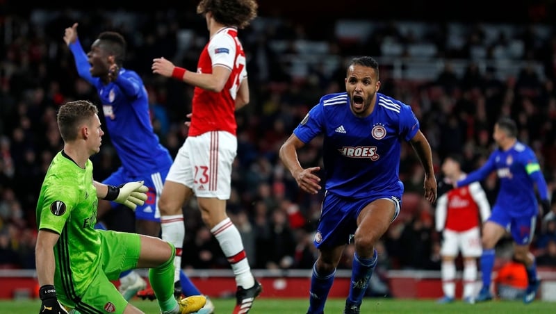 Youssef El-Arabi celebrates (C) after scoring the decisive goal for Olympiacos