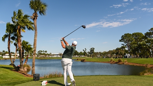 Shane Lowry of Ireland tees off on the ninth