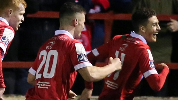Jaze Kabia (right) leads the celebrations after firing Shelbourne in front