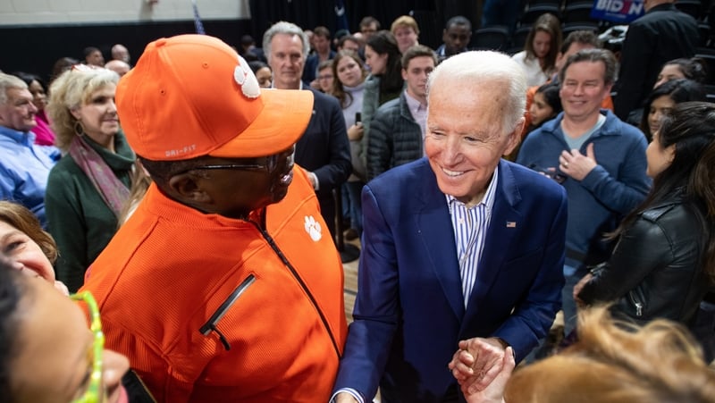 Joe Biden shakes hands with supporters during a campaign event at Wofford University