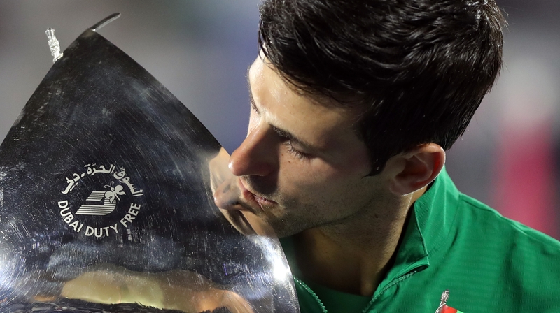 Novak Djokovic of Serbia celebrates with the victor's trophy