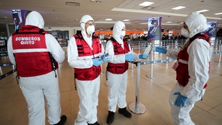 Health workers check arrivals at the Mariscal Sucre International Airport in Quito, Ecuador, today