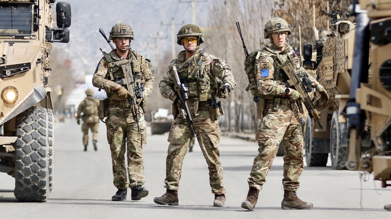 British soldiers stand guard at the site where a gunman opened fire