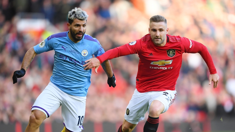 Luke Shaw (r) and Sergio Aguero battle for possession