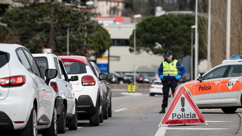 Police check border crossers along the Italian-Swiss border in the Lombardy region