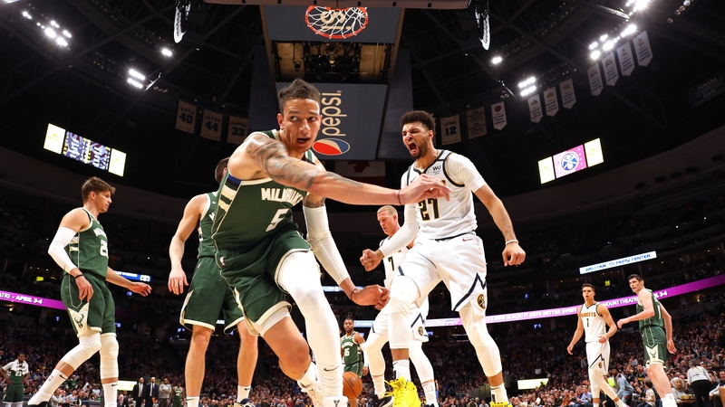 Jamal Murray #27 of the Denver Nuggets dunks over the Bucks' D.J. Wilson