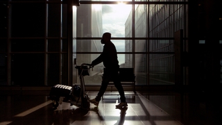A traveller wears a mask in an airport in Barcelona