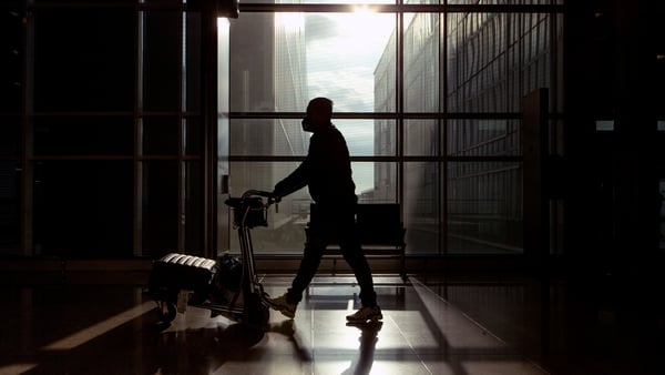 A traveller wears a mask in an airport in Barcelona