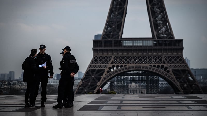 Police control people at the Eiffel Tower in Paris