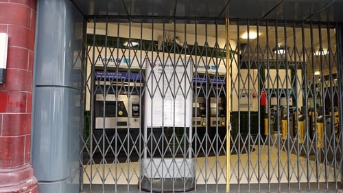 A sign behind a closed entrance grille at Covent Garden Station