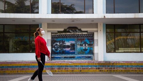 A woman plays badminton in Beijing, China as life slowly returns nearly two months after Wuhan was put under lockdown