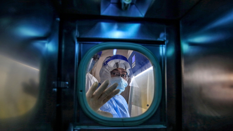 A medical staff member gestures inside an isolation ward at Red Cross Hospital in Wuhan