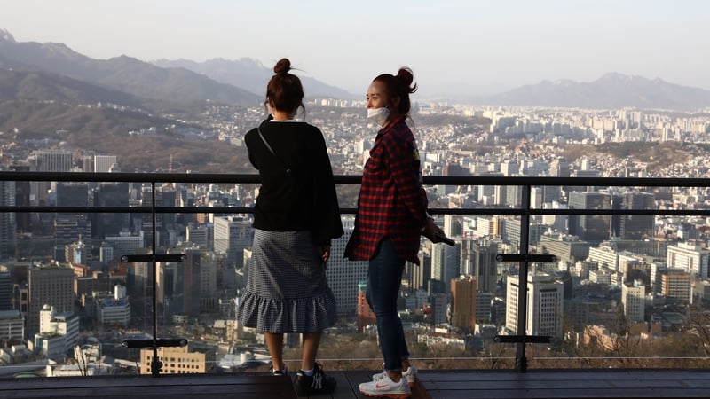 People watch the sun set in Seoul