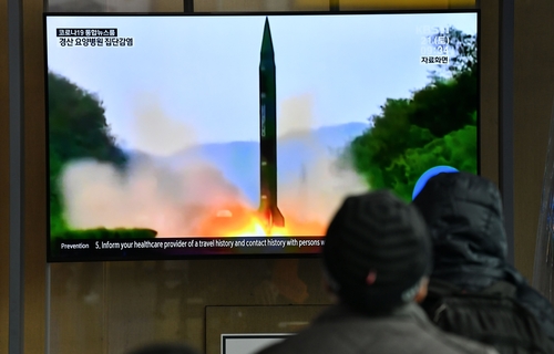 People watch a broadcast showing a file image of a North Korean missile test, in Seoul, South Korea on 21 March, 2020
