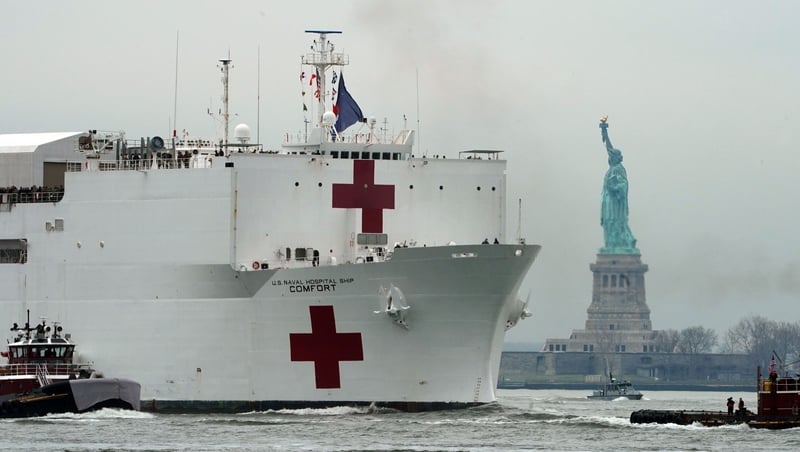 The USNS Comfort medical ship moves up the Hudson River past the Statue of Liberty as it arrives in New York