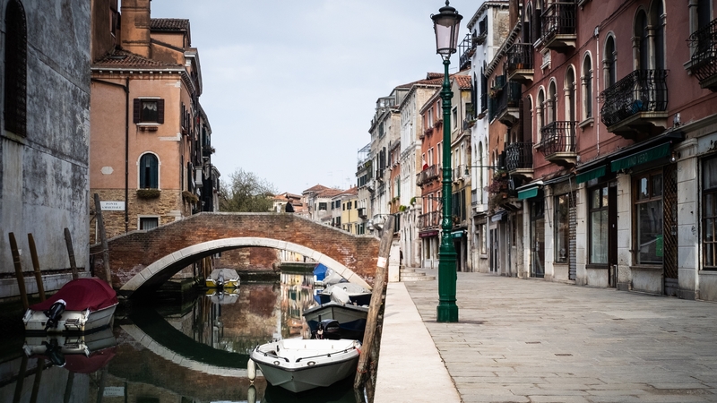 Buildings are reflected in a calm water due to the absence of motor boats in Venice, Italy, today