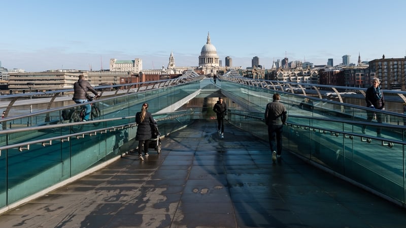 People observe social distancing on the Millennium Bridge in London
