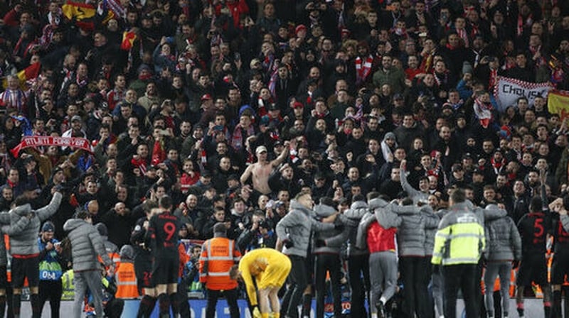 Atletico fans in the Anfield stands celebrate the win over Liverpool