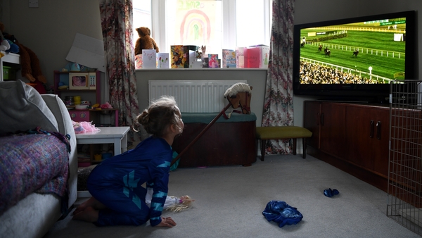 Lois Copley-Jones, aged 5, watches the Virtual Grand National