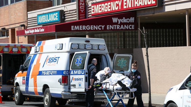 Healthcare workers help a patient at the Wyckoff Heights Medical Center in Brooklyn