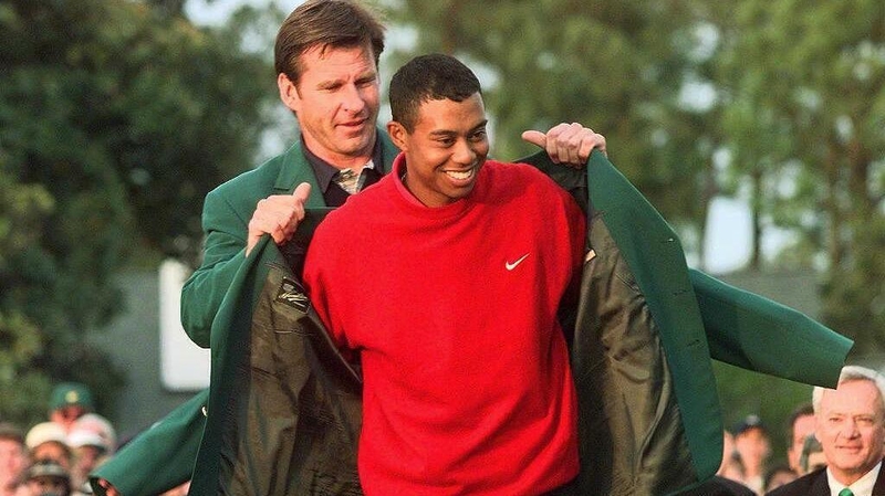 Nick Faldo helps Tiger Woods into the Green Jacket in 1997