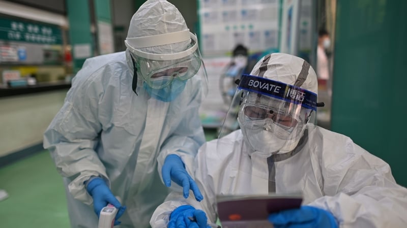 Lab technicians check swabs from people tested for Covid-19