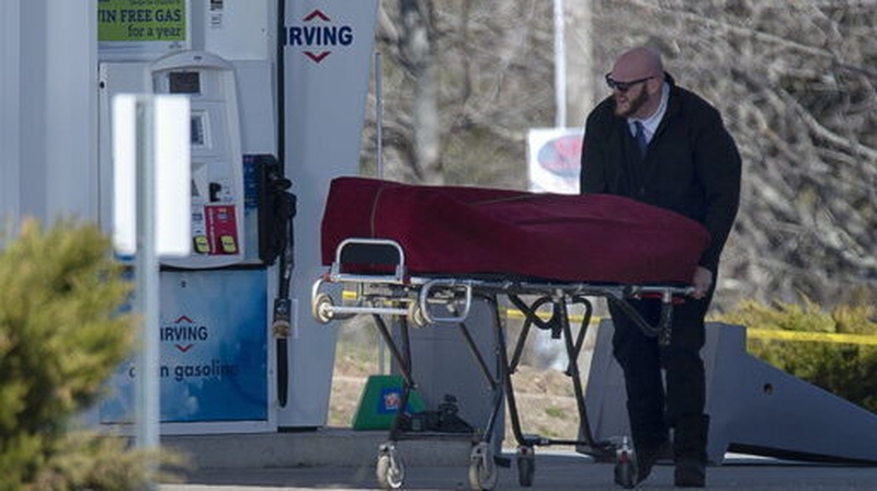 A body is removed following a shooting incident that began in the small coastal village of Portapique, Nova Scotia