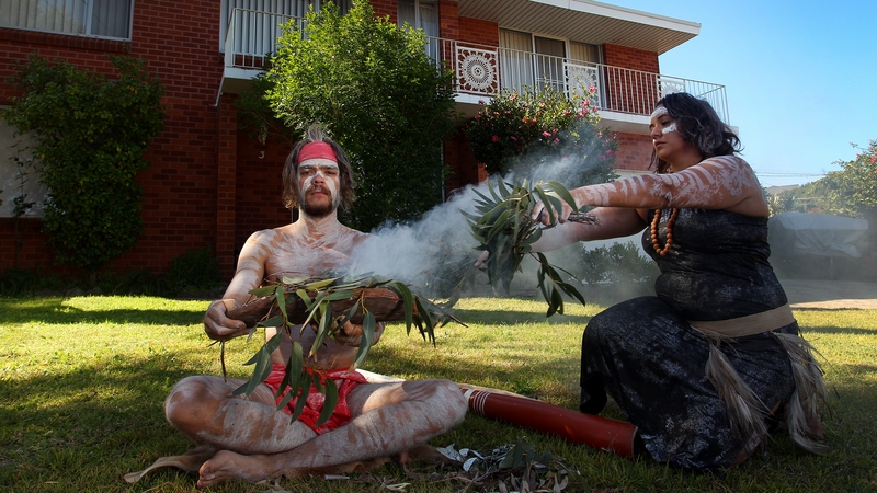Brock Tutt and Bianca Williams perform a traditional smoking ceremony at their home in New South Wales, Australia, as part of the Haka and Corroboree for Anzac Day