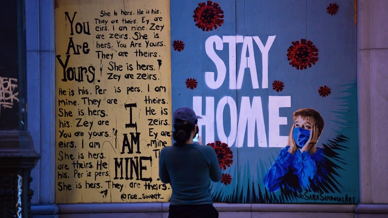 A woman views a public art installation aimed at turning boarded up shopfronts into works of art in Los Angeles, California