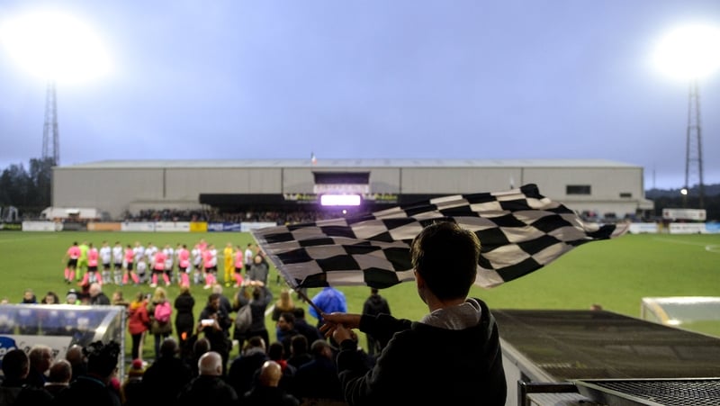 A Dundalk fan waves a flag at Oriel Park