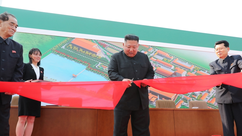 Kim Jong-un pictured cutting the ribbon at the opening of what state media said was a fertiliser factory
