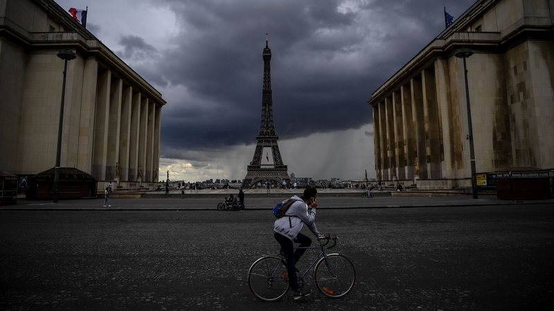 A man rides a bicycle past the Trocadero Esplanade