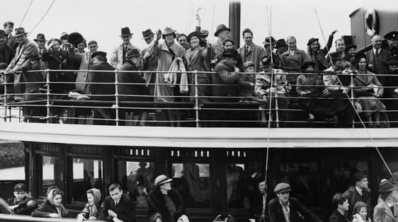 Passengers aboard the tender which will transfer them to the 'President Roosevelt' wave farewell to…