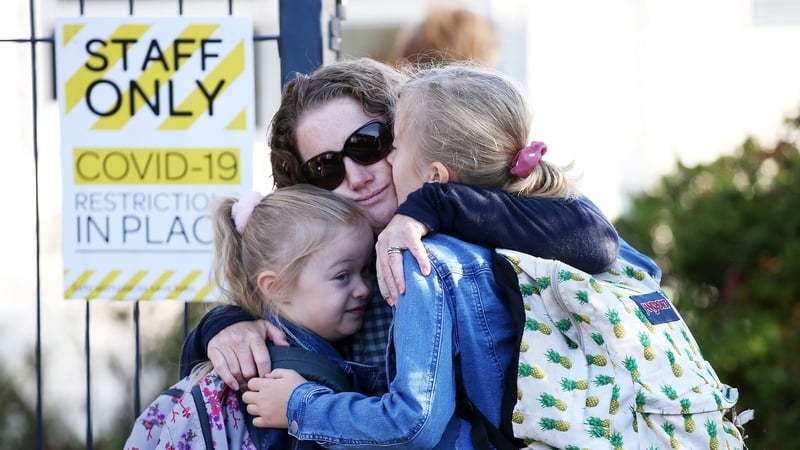 Kirsty Barton hugs her children Isla and Elsie goodbye at Laingholm Primary School in Auckland
