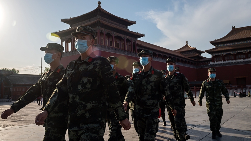 People's Liberation Army (PLA) soldiers march in front of the entrance of the Forbidden City in Beijing