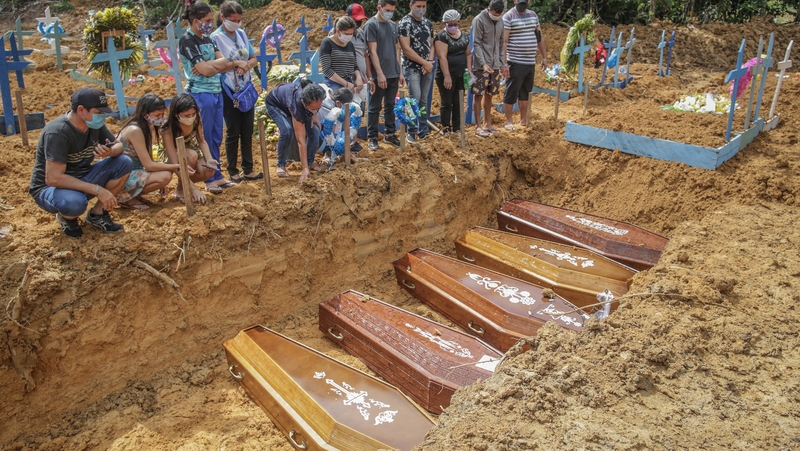 Relatives attend a mass burial in Manaus, Brazil