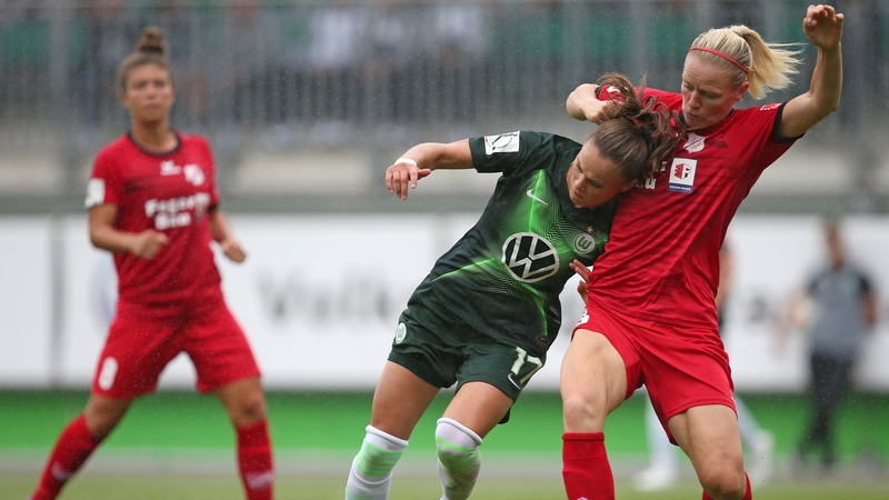 (L-R) Ewa Pajor of VfL Wolfsburg and Diane Caldwell of SC Sand and Ireland in action in 2019