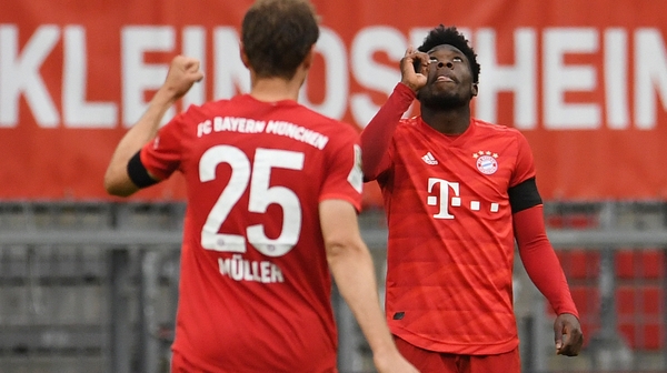 Alphonso Davies, right, celebrates scoring Bayern's fourth goal with team-mate Thomas Muller