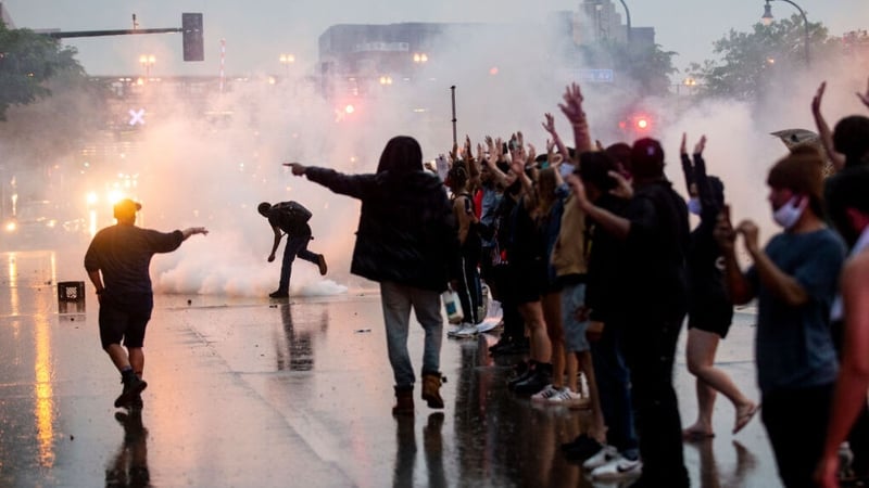Video showed crowds gathered outside the Minneapolis Police Department's third precinct as riot police fired tear gas
