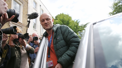 Dominic Cummings is flanked by photographers as he gets into his car outside his home earlier this week