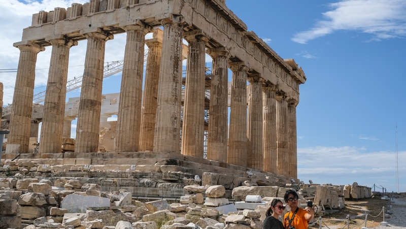 Tourists hike around the Acropolis in Athens earlier this month