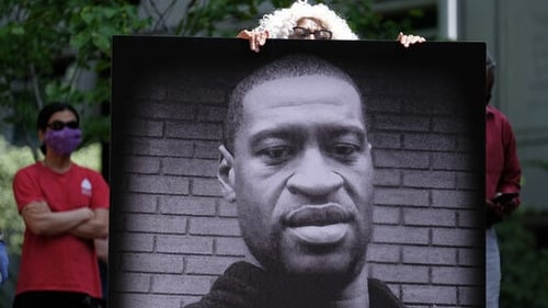 Protesters hold up a photo of George Floyd in Portland, Oregon