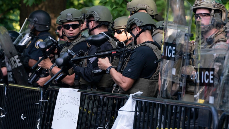 Police officers hold pellet guns during a demonstration in Washington, DC