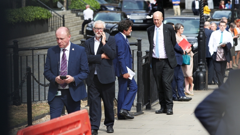 MPs queue outside the House of Commons in Westminster, London, as they wait to vote on the future of proceedings